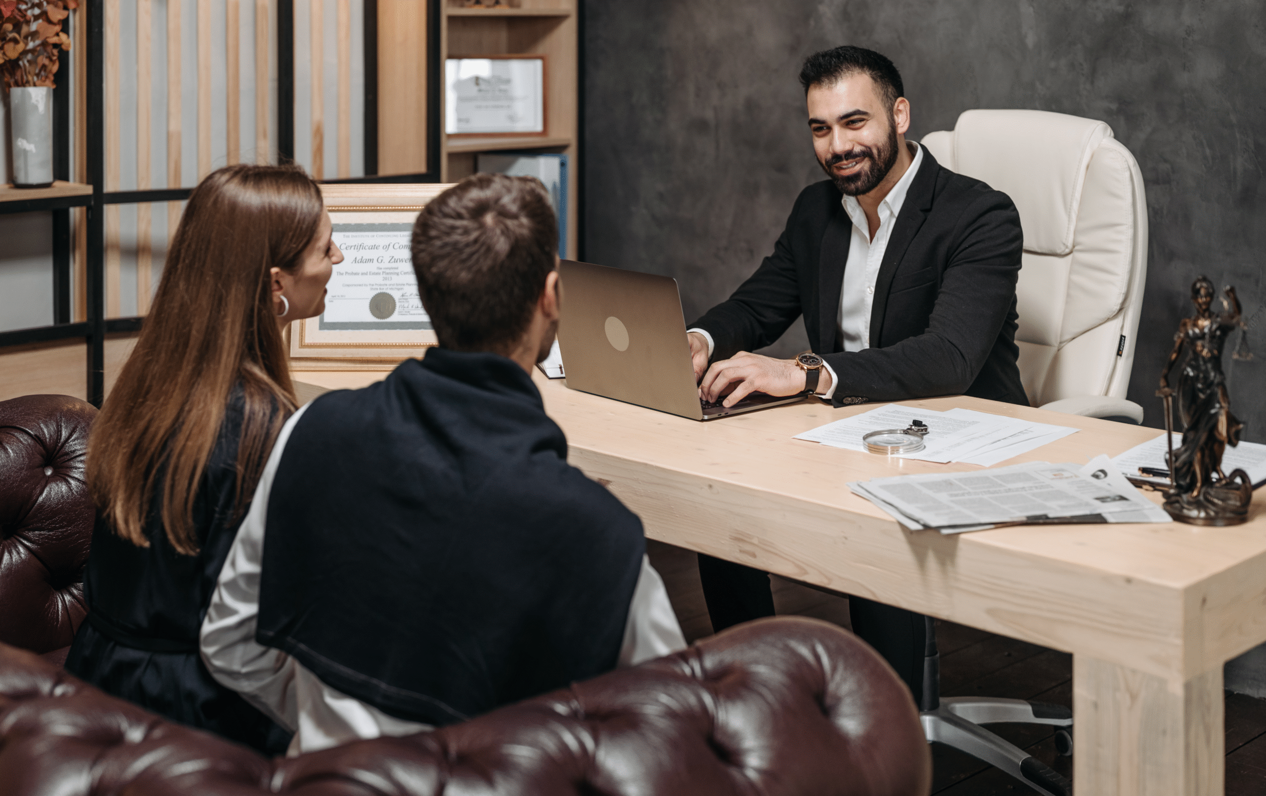 A lawyer sitting down to work with two clients