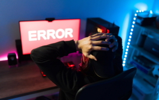 Man frustrated looking at his screen after getting an error screen signaling a cyber-attack